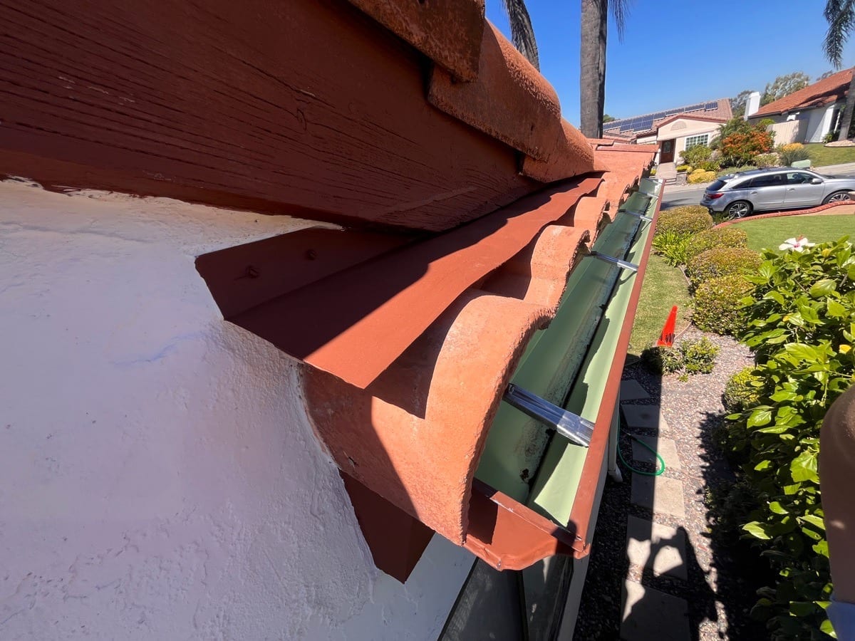 6-inch gutter upgrade with hidden mounts along a tile roof edge